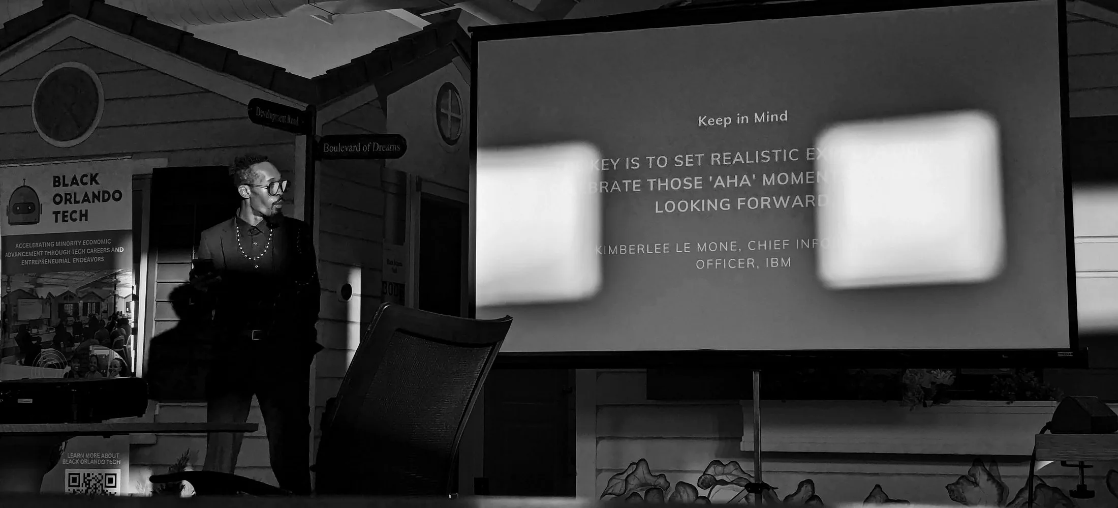 David speaking at Black Orlando Tech, small beside a projected slide